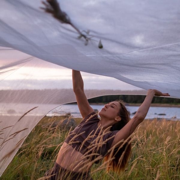 Woman in a graceful yoga pose, embodying peace and balance.